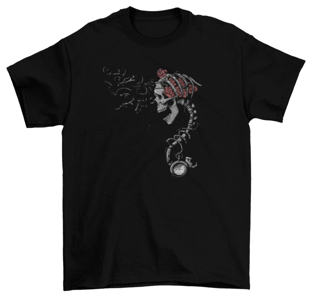 Set against a black t-shirt, the Time Keeper Skull artwork features a haunting skeletal figure emerging from the chest, its spine extending downward into a vintage pocket watch, symbolising the fragile link between life and time.&nbsp;